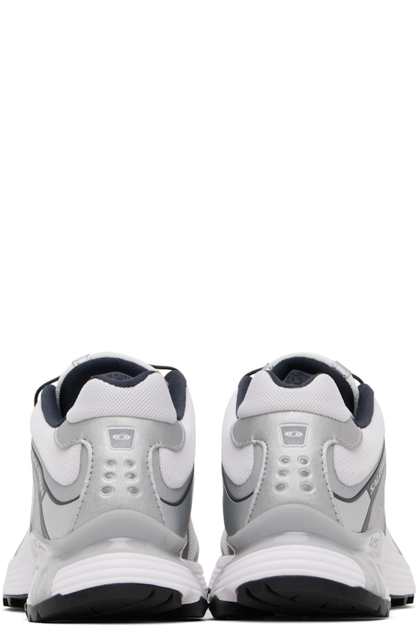 Low-top anti-debris 3D mesh and faux-leather sneakers.

· Reflective trim throughout
· Perforations and embossed logo at toe
· Quicklace™ closure
· Logo patch at padded tongue
· Padded collar
· Bonded sensiFIT™ panel at sides
· Logo printed at outer side and heel tab
· Molded OrthoLite® footbed
· Mesh lining
· Agile Chassis™ System at foam rubber EnergyCell midsole
· Treaded Mud Contagrip® rubber sole

Supplier color: White/Ftw silver/Dark navy