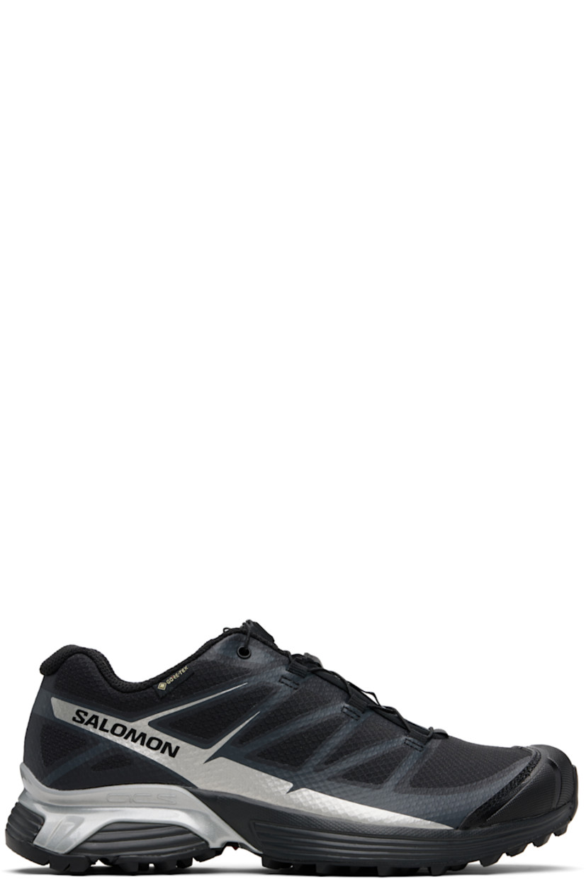 Low-top mesh sneakers.

· Waterproof GORE-TEX™ membrane
· Bonded trim throughout
· Quicklace™ closure
· Logo patch at vamp
· Logo-woven pull-loop at tongue
· Padded tongue and collar
· Logo printed at outer side
· Bonded SensiFit™ panel at sides
· Molded OrthoLite® insole
· Mesh lining
· Agile Chassis™ Skeleton at EnergyCell midsole
· Treaded Mud Contagrip® rubber sole

Supplier color: Black/Black/Ftw silver