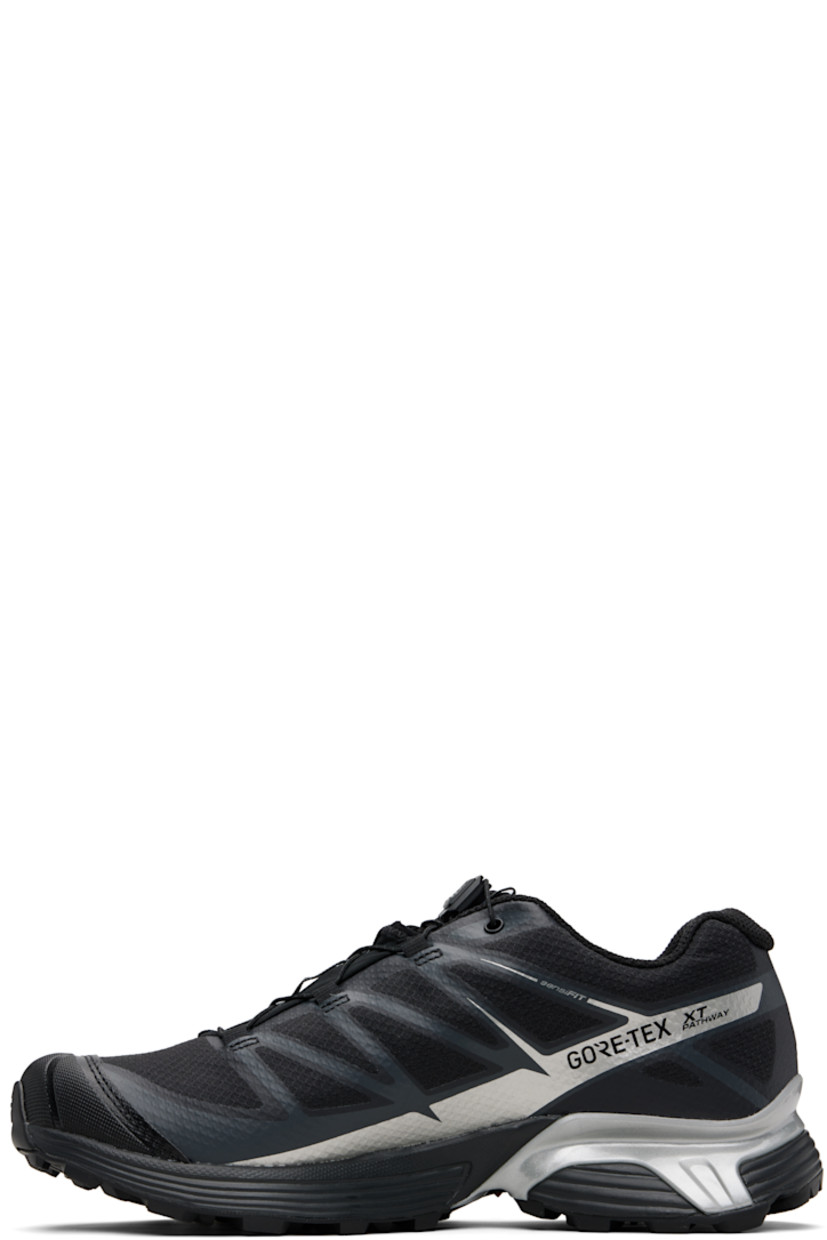 Low-top mesh sneakers.

· Waterproof GORE-TEX™ membrane
· Bonded trim throughout
· Quicklace™ closure
· Logo patch at vamp
· Logo-woven pull-loop at tongue
· Padded tongue and collar
· Logo printed at outer side
· Bonded SensiFit™ panel at sides
· Molded OrthoLite® insole
· Mesh lining
· Agile Chassis™ Skeleton at EnergyCell midsole
· Treaded Mud Contagrip® rubber sole

Supplier color: Black/Black/Ftw silver