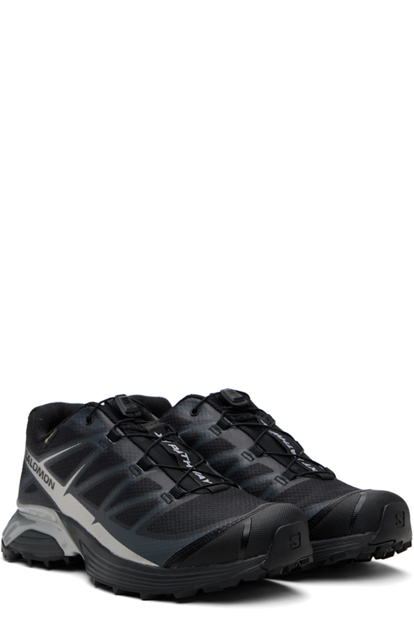 Low-top mesh sneakers.

· Waterproof GORE-TEX™ membrane
· Bonded trim throughout
· Quicklace™ closure
· Logo patch at vamp
· Logo-woven pull-loop at tongue
· Padded tongue and collar
· Logo printed at outer side
· Bonded SensiFit™ panel at sides
· Molded OrthoLite® insole
· Mesh lining
· Agile Chassis™ Skeleton at EnergyCell midsole
· Treaded Mud Contagrip® rubber sole

Supplier color: Black/Black/Ftw silver
