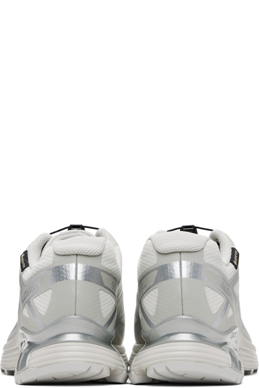 Low-top mesh sneakers.

· Waterproof GORE-TEX™ membrane
· Bonded trim throughout
· Quicklace™ closure
· Logo patch at vamp
· Logo-woven pull-loop at tongue
· Padded tongue and collar
· Logo printed at outer side
· Bonded SensiFit™ panel at sides
· Molded OrthoLite® insole
· Mesh lining
· Agile Chassis™ Skeleton at EnergyCell midsole
· Treaded Mud Contagrip® rubber sole

Supplier color: Lunar rock/Alloy/Ftw silver