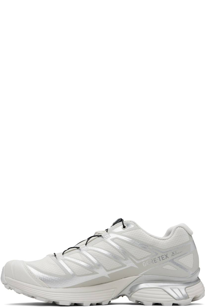 Low-top mesh sneakers.

· Waterproof GORE-TEX™ membrane
· Bonded trim throughout
· Quicklace™ closure
· Logo patch at vamp
· Logo-woven pull-loop at tongue
· Padded tongue and collar
· Logo printed at outer side
· Bonded SensiFit™ panel at sides
· Molded OrthoLite® insole
· Mesh lining
· Agile Chassis™ Skeleton at EnergyCell midsole
· Treaded Mud Contagrip® rubber sole

Supplier color: Lunar rock/Alloy/Ftw silver