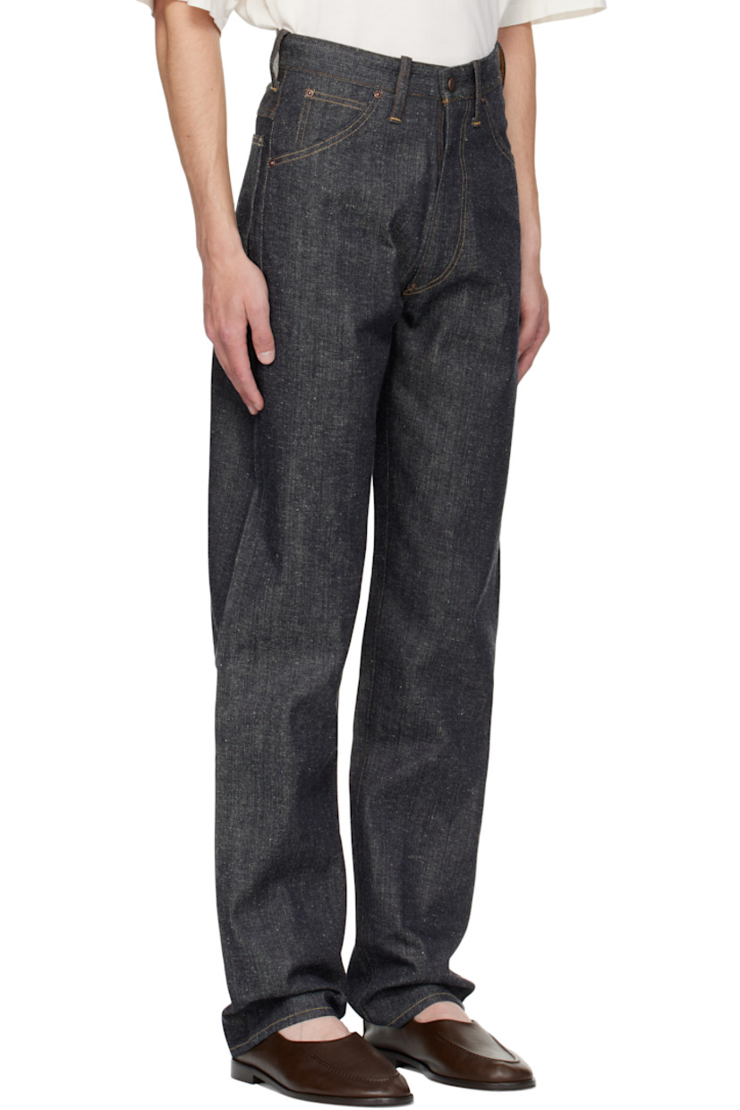 Non-stretch organic cotton sanforized denim jeans.

· Indigo- and sulfur-dyed
· Belt loops
· Five-pocket styling
· Zip fly
· Cinch strap at back waistband
· Mud-dyed leather patch at back waistband
· Contrast stitching in tan

Supplier color: Raw Indigo
