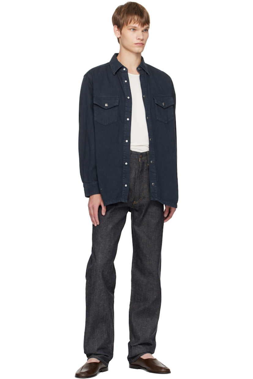 Non-stretch organic cotton sanforized denim jeans.

· Indigo- and sulfur-dyed
· Belt loops
· Five-pocket styling
· Zip fly
· Cinch strap at back waistband
· Mud-dyed leather patch at back waistband
· Contrast stitching in tan

Supplier color: Raw Indigo