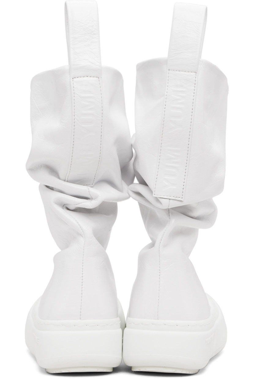 Mid-calf crinkled leather boots.

· Gathering throughout
· Logo-embossed pull-loops at collar
· Grained faux-leather lining
· Logo-embossed rubber platform midsole
· Treaded rubber sole
· Platform: H1.75"

Supplier color: Wrinkled white
