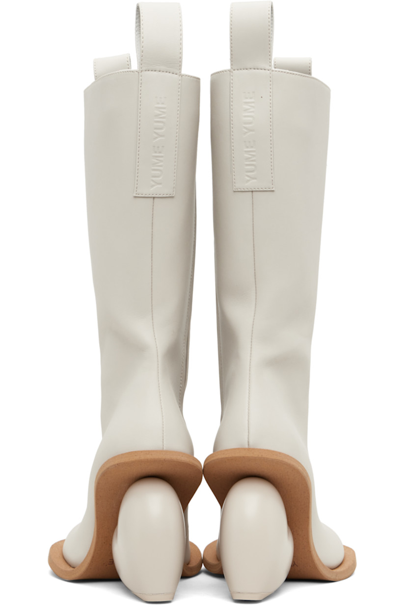 Knee-high buffed faux-leather boots.

· Logo-embossed pull-loops at collar
· Zip closure at inner side
· Grained faux-leather lining
· Sculptural heel
· Rubber sole
· Heel: H4.25"

Available exclusively at SSENSE.

Supplier color: Rainday