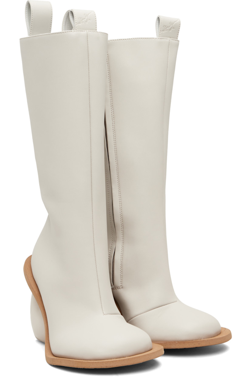 Knee-high buffed faux-leather boots.

· Logo-embossed pull-loops at collar
· Zip closure at inner side
· Grained faux-leather lining
· Sculptural heel
· Rubber sole
· Heel: H4.25"

Available exclusively at SSENSE.

Supplier color: Rainday