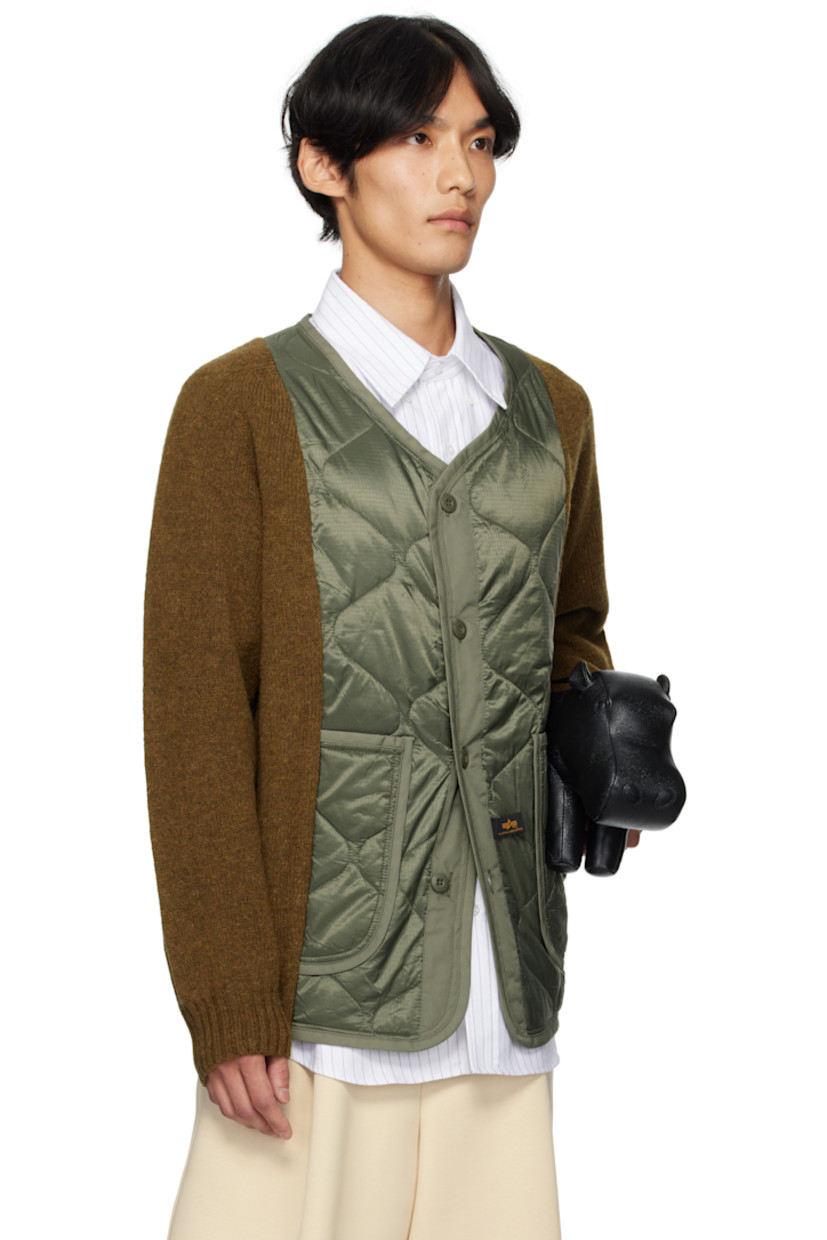 Paneled knit Shetland wool jacket.

· Alpha Industries® quilted ripstop panel at front
· V-neck
· Button closure
· Patch pockets at waist
· Logo hardware at side seam
· Button holes at back collar

Supplier color: Olive