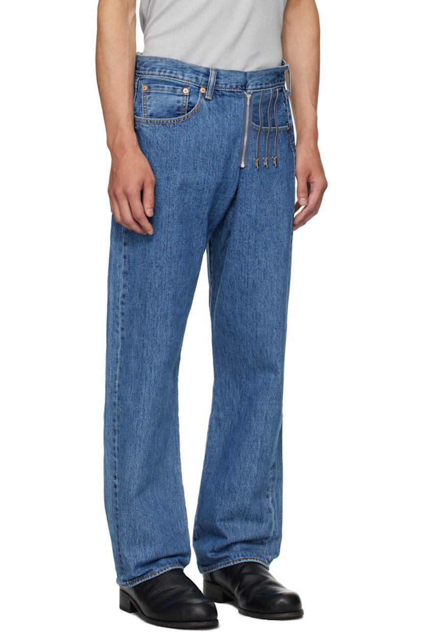 Upcycled non-stretch denim jeans.

· Belt loops
· Adjustable foldover waistband with zip closure
· Four-pocket styling
· Button fly
· Logo hardware at front pocket
· Logo patch at back waistband
· Logo flag at back pocket
· Contrast stitching in orange and yellow

Supplier color: Litblue