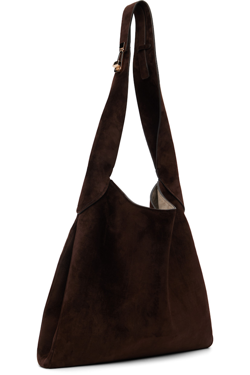 Calfskin suede tote.

· Turn-lock fastening at shoulder strap
· Magnetic closure
· H13" x W14" x D2"

Supplier color: Dark brown