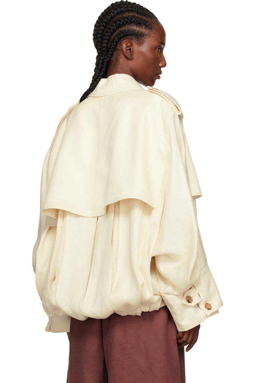 Linen textured hopsack jacket. 

· Oversized
· Spread collar
· Draped button panel at zip closure
· Buttoned storm flap at chest and back yoke 
· Welt pockets at waist
· Gathering and cord-lock drawstring at hem 
· Epaulets
· Button tab at buttoned barrel cuffs

Supplier color: Ivory