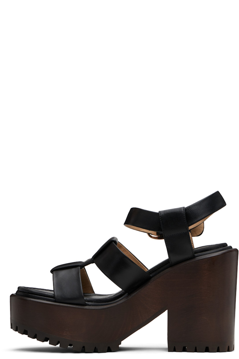 Buffed leather heeled sandals.

· Open almond toe
· Pin-buckle ankle strap
· Logo-embossed padded leather footbed
· Wooden block heel and platform midsole
· Treaded rubber sole
· Platform: H2"
· Heel: H4.25"

Supplier color: Black