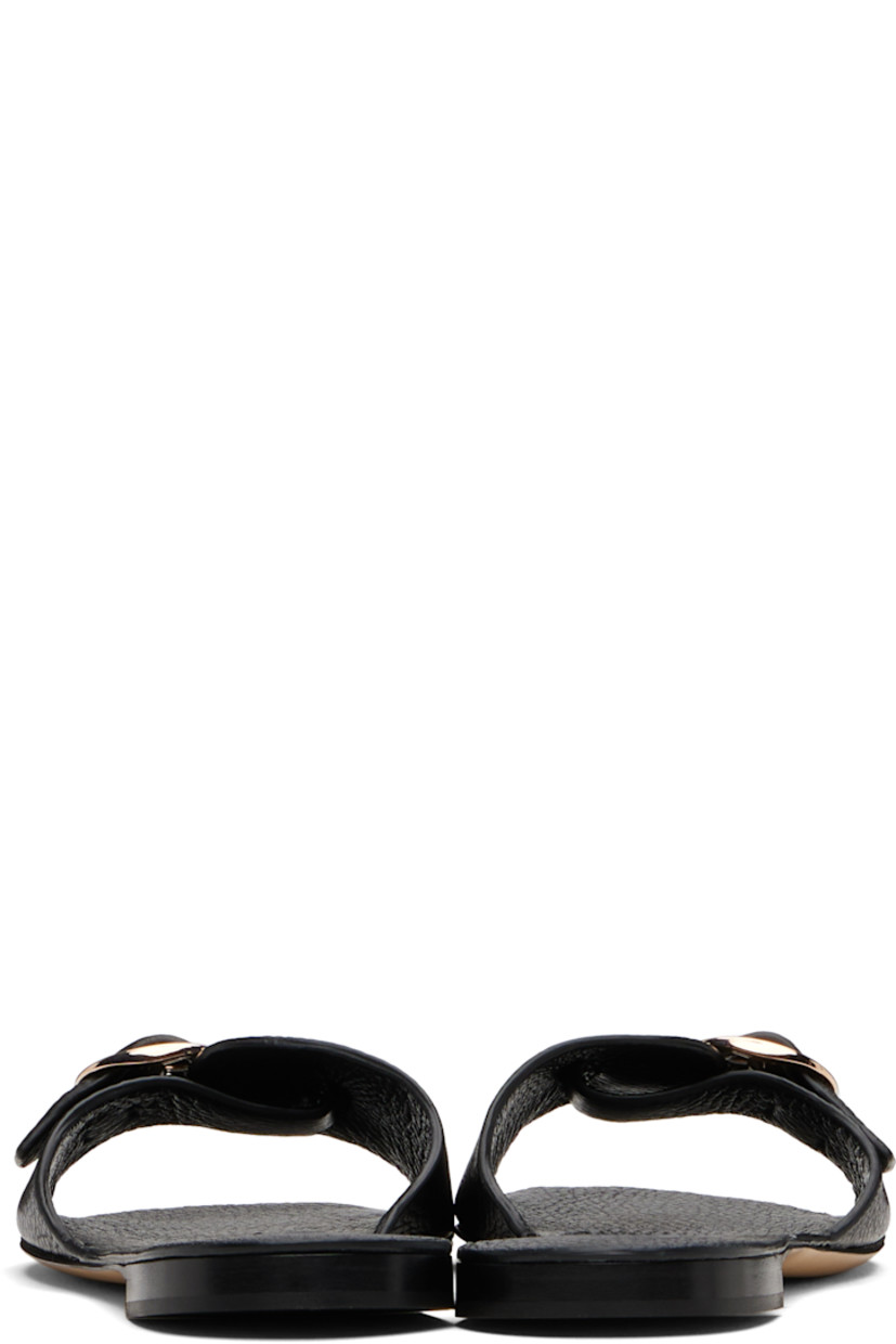 Grained deer leather slides.

· Open toe
· Pin-buckle strap at vamp
· Logo patch at footbed
· Stacked leather heel with rubber injection
· Leather sole

Supplier color: Black