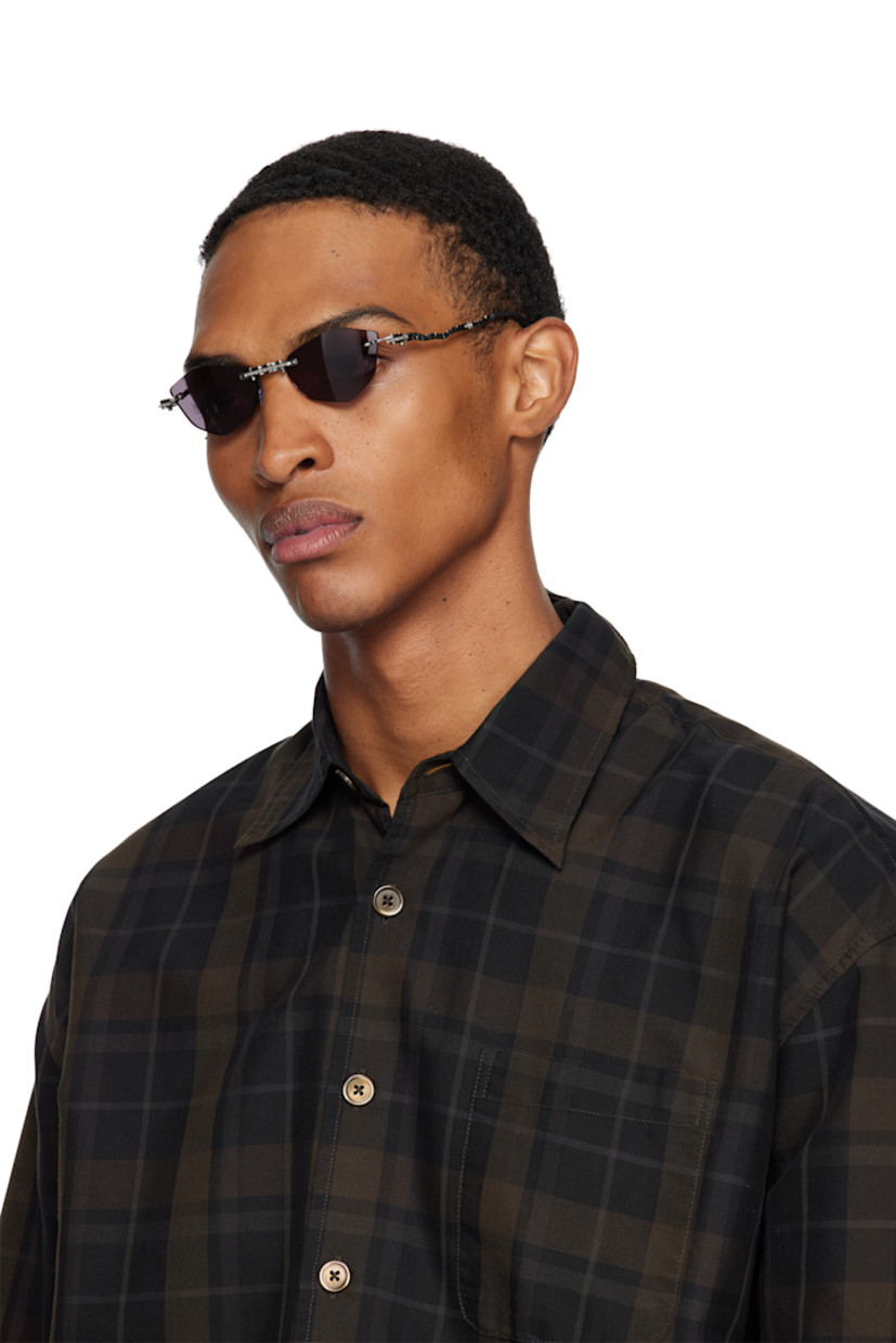 Handcrafted collapsible hexagonal metal-frame sunglasses.

· Spur gears at hinges
· Engraved detailing throughout
· Gray lenses
· Adjustable metal nose pads
· Sculptural arms
· Acetate temple tips
· Includes case
· Size: 51.19 140

Supplier color: Gunmetal