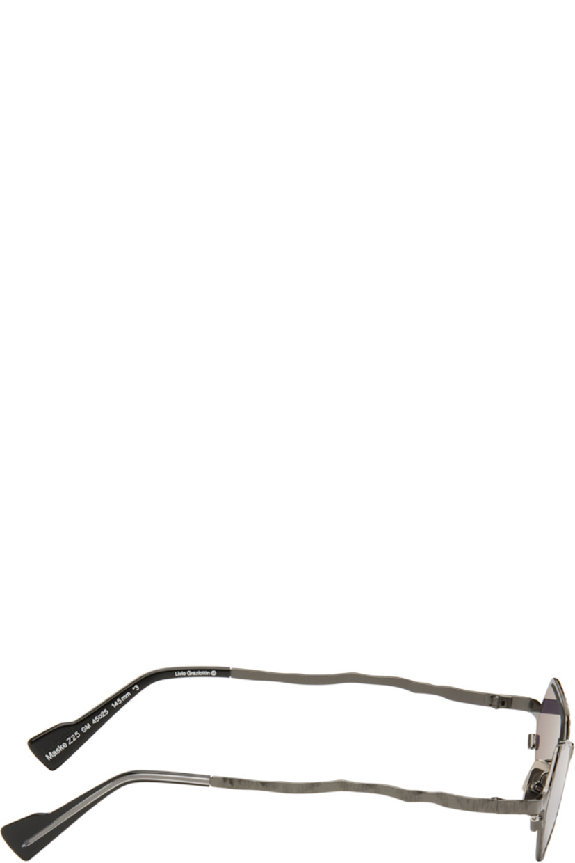Handcrafted hexagonal metal-frame sunglasses.

· Engraved detailing throughout
· Purple lenses
· Adjustable metal nose pads
· Acetate temple tips
· Includes pouch
· Size: 45.25 145

Supplier color: Gunmetal