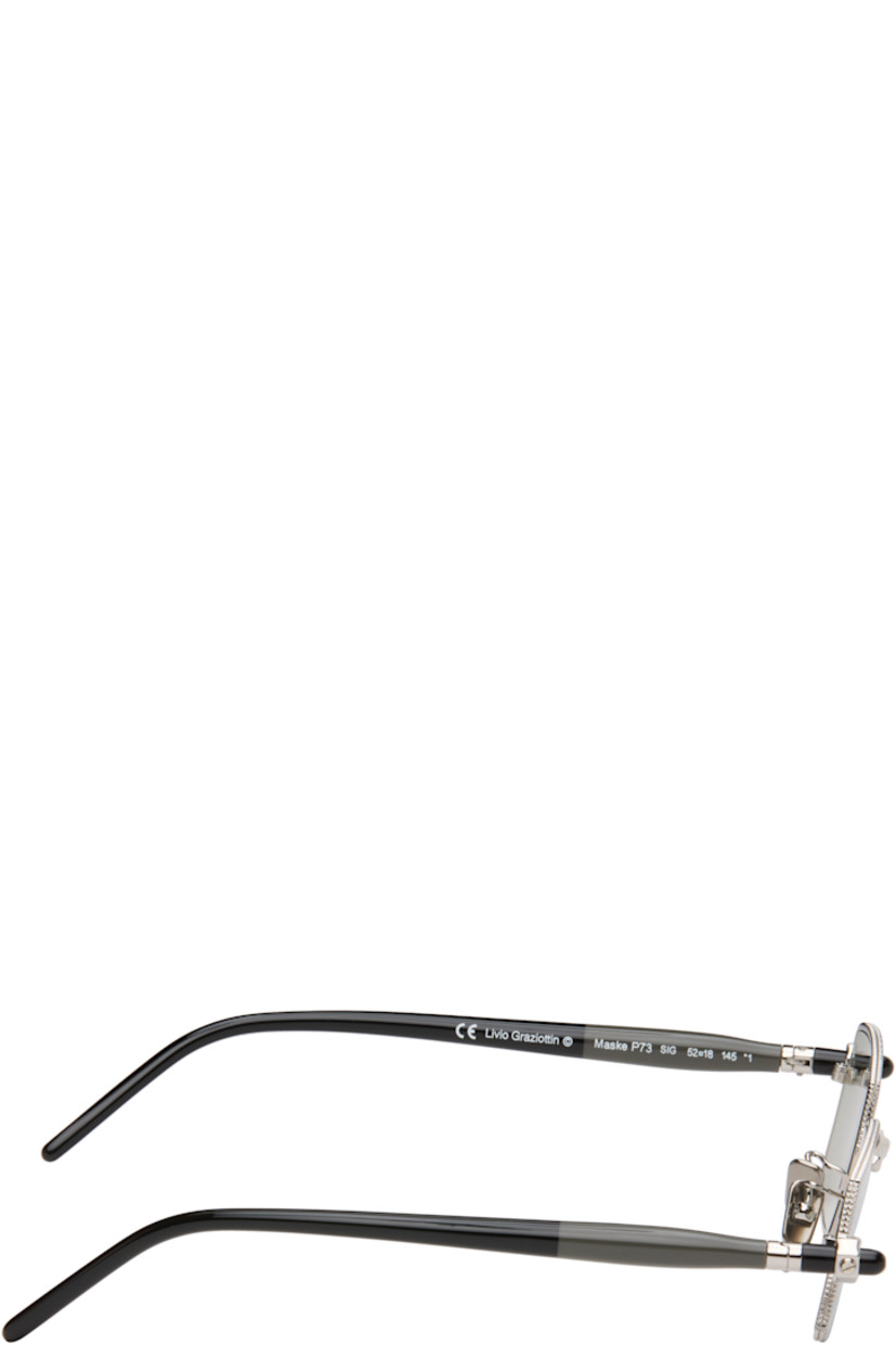 Handcrafted rectangular metal-frame sunglasses.

· Gray lenses
· Serrated detailing at rims
· Adjustable metal nose pads
· Acetate arms
· Includes case
· Size: 52.18 145

Supplier color: Silver/Grey/Black shine