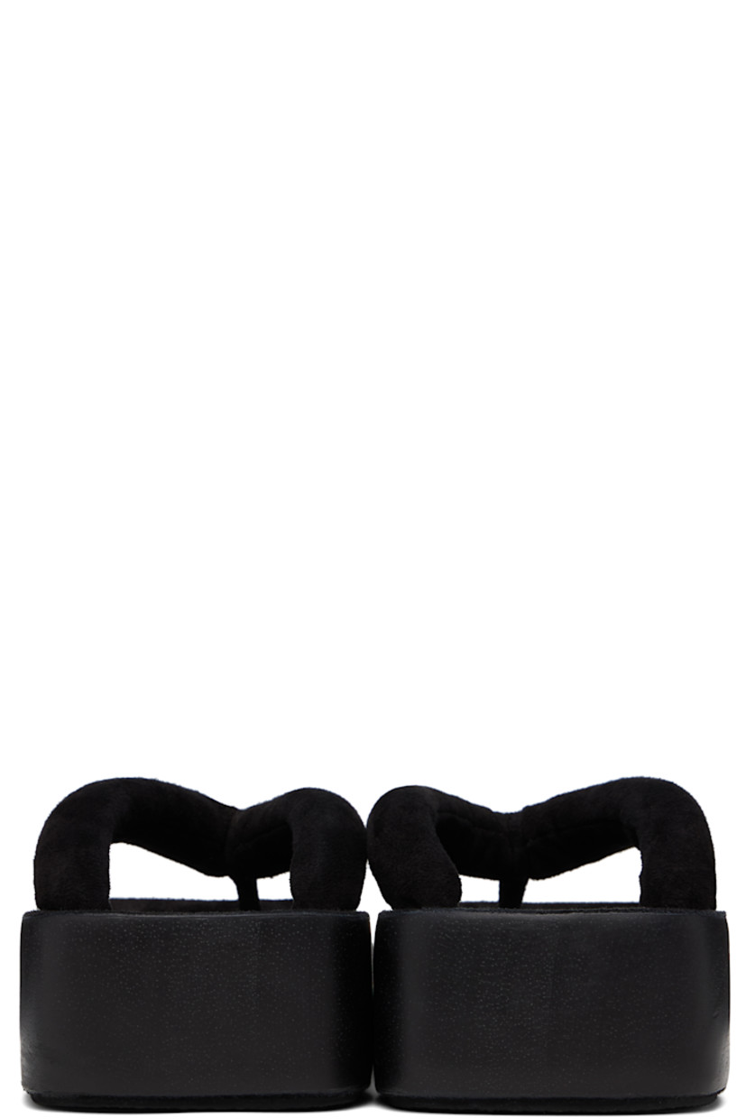 Handcrafted padded suede sandals in black.

· Open square toe
· Thong-style strap at vamp
· Logo embossed at molded footbed
· Hand-painted wood midsole
· Crêpe rubber sole
· Platform: H1.75"

Supplier color: Black
