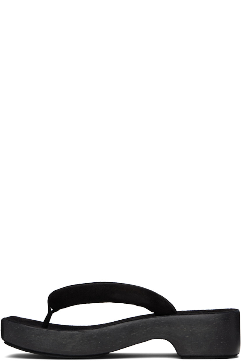 Handcrafted padded suede sandals in black.

· Open square toe
· Thong-style strap at vamp
· Logo embossed at molded footbed
· Hand-painted wood midsole
· Crêpe rubber sole
· Platform: H1.75"

Supplier color: Black
