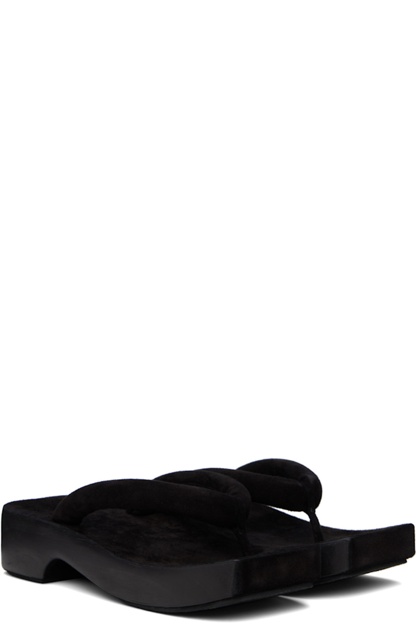 Handcrafted padded suede sandals in black.

· Open square toe
· Thong-style strap at vamp
· Logo embossed at molded footbed
· Hand-painted wood midsole
· Crêpe rubber sole
· Platform: H1.75"

Supplier color: Black