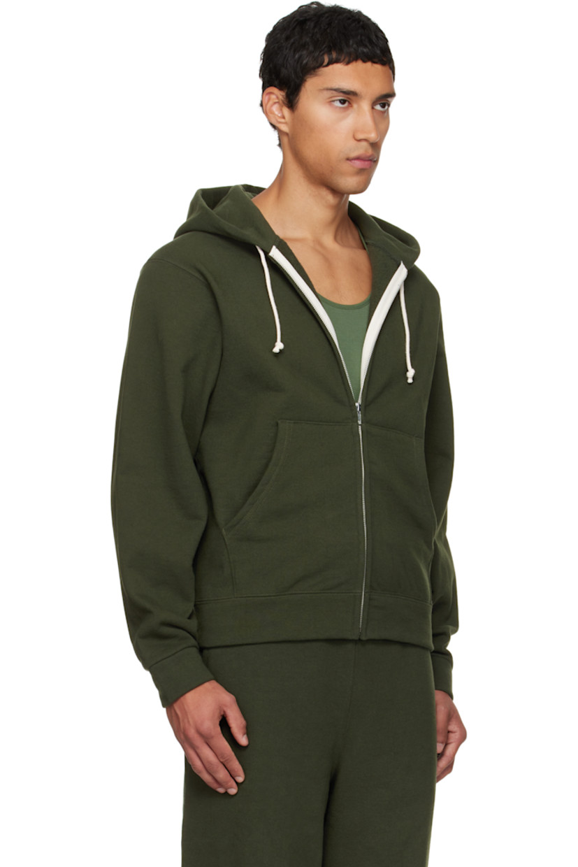 14 oz cotton fleece hoodie.

· Drawstring at hood
· Zip closure
· Patch pockets at waist
· Rib-knit hem and cuffs
· Piping at side seams and sleeves

Available exclusively at SSENSE.

Supplier color: Park green