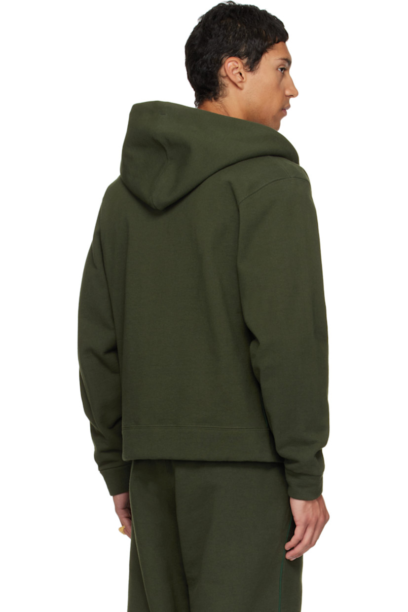 14 oz cotton fleece hoodie.

· Drawstring at hood
· Zip closure
· Patch pockets at waist
· Rib-knit hem and cuffs
· Piping at side seams and sleeves

Available exclusively at SSENSE.

Supplier color: Park green