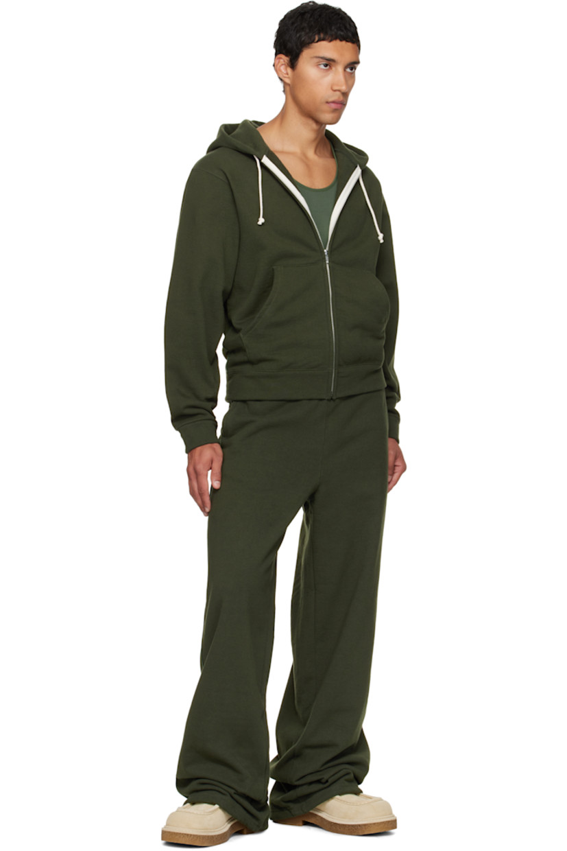 14 oz cotton fleece hoodie.

· Drawstring at hood
· Zip closure
· Patch pockets at waist
· Rib-knit hem and cuffs
· Piping at side seams and sleeves

Available exclusively at SSENSE.

Supplier color: Park green
