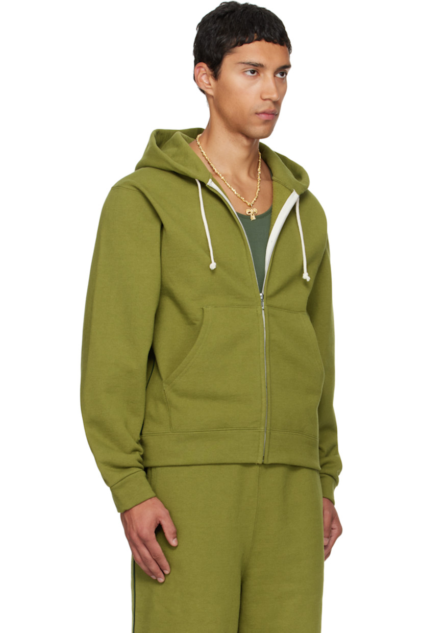 14 oz cotton fleece hoodie.

· Drawstring at double-faced hood
· Zip closure
· Patch pockets at waist
· Rib-knit hem and cuffs
· Piping at side seams and sleeves
· Dropped shoulders

Available exclusively at SSENSE.

Supplier color: Olive branch