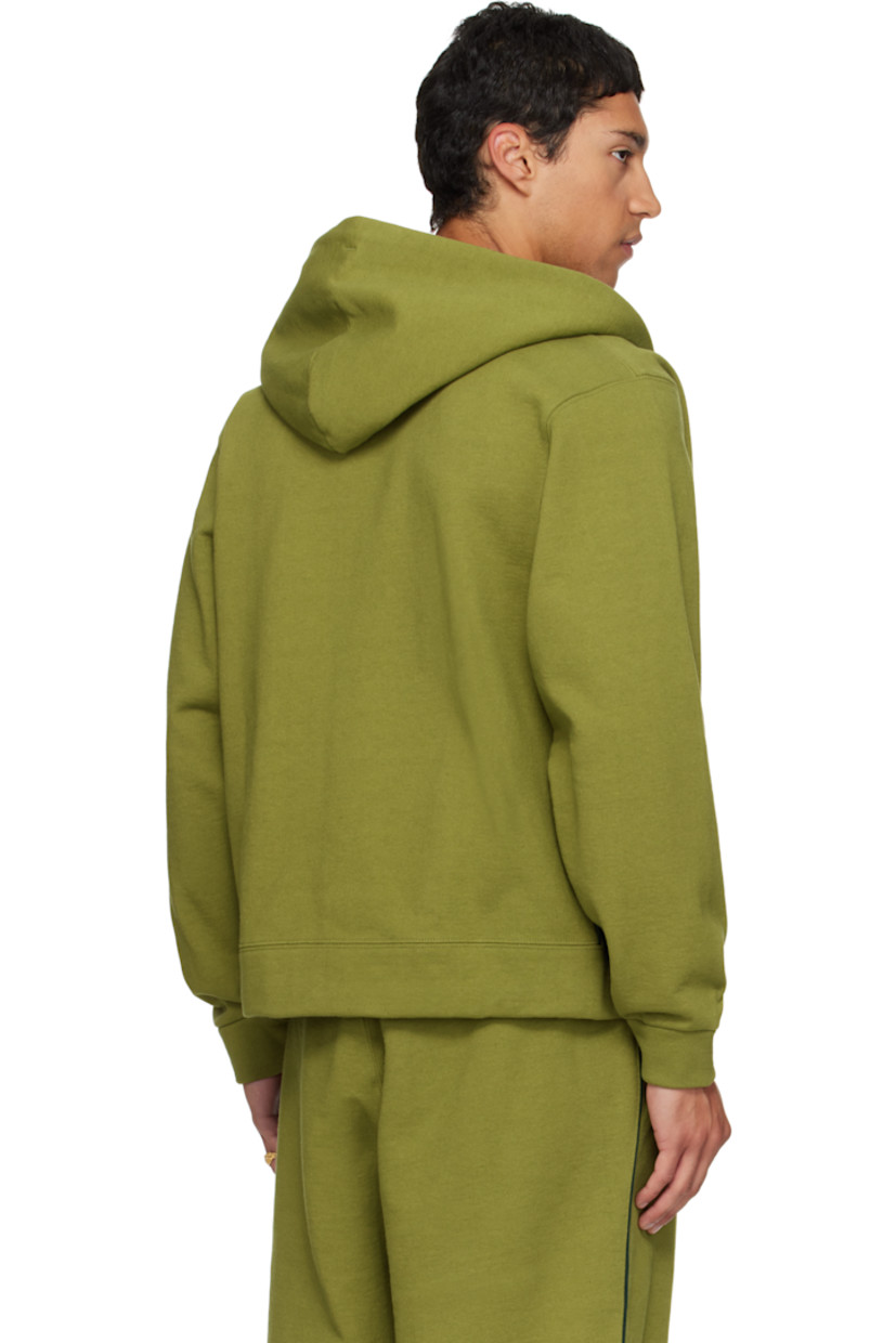 14 oz cotton fleece hoodie.

· Drawstring at double-faced hood
· Zip closure
· Patch pockets at waist
· Rib-knit hem and cuffs
· Piping at side seams and sleeves
· Dropped shoulders

Available exclusively at SSENSE.

Supplier color: Olive branch