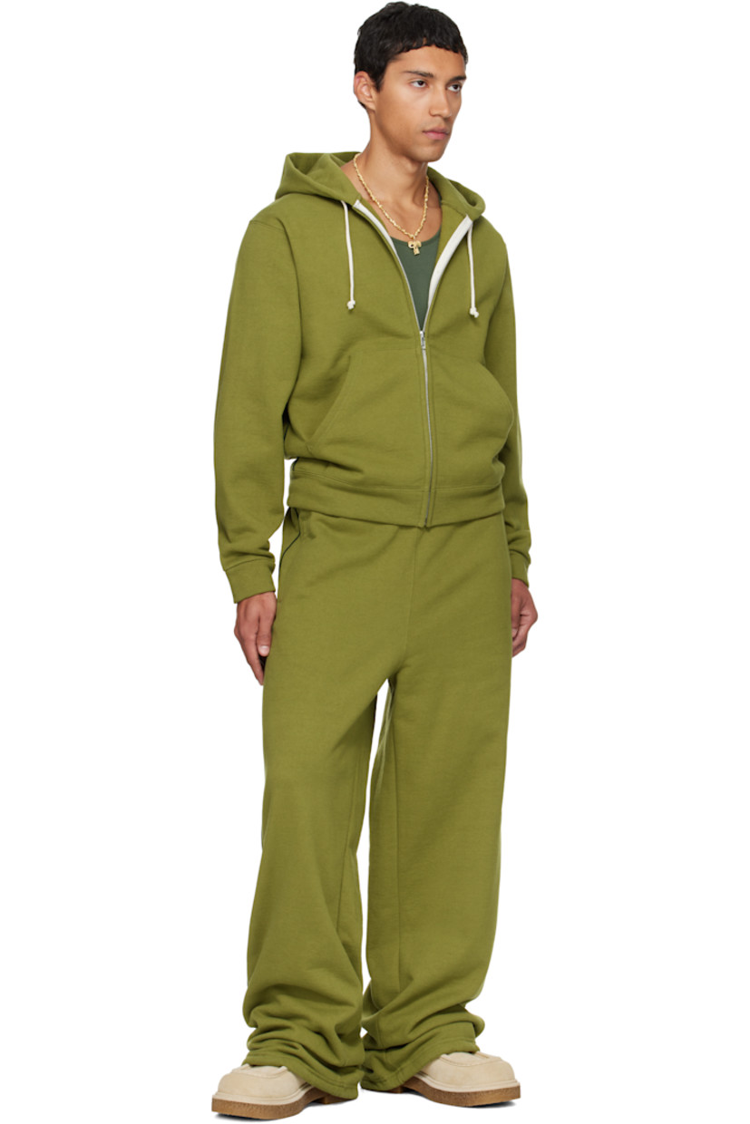 14 oz cotton fleece hoodie.

· Drawstring at double-faced hood
· Zip closure
· Patch pockets at waist
· Rib-knit hem and cuffs
· Piping at side seams and sleeves
· Dropped shoulders

Available exclusively at SSENSE.

Supplier color: Olive branch
