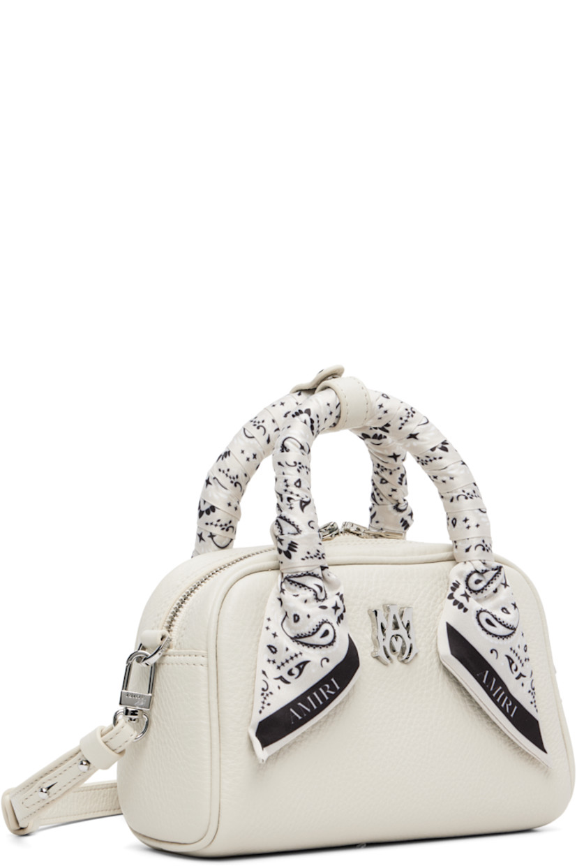 Pebble-grained leather top handle bag.

· Press-stud tab at bandana-wrapped twin carry handles
· Adjustable and detachable crossbody strap
· Logo hardware at face
· Two-way zip closure
· Card slot at interior
· Logo-woven lining
· Logo-engraved silver-tone hardware
· H4.5" x W7.25" x D3"

Supplier color: Alabaster