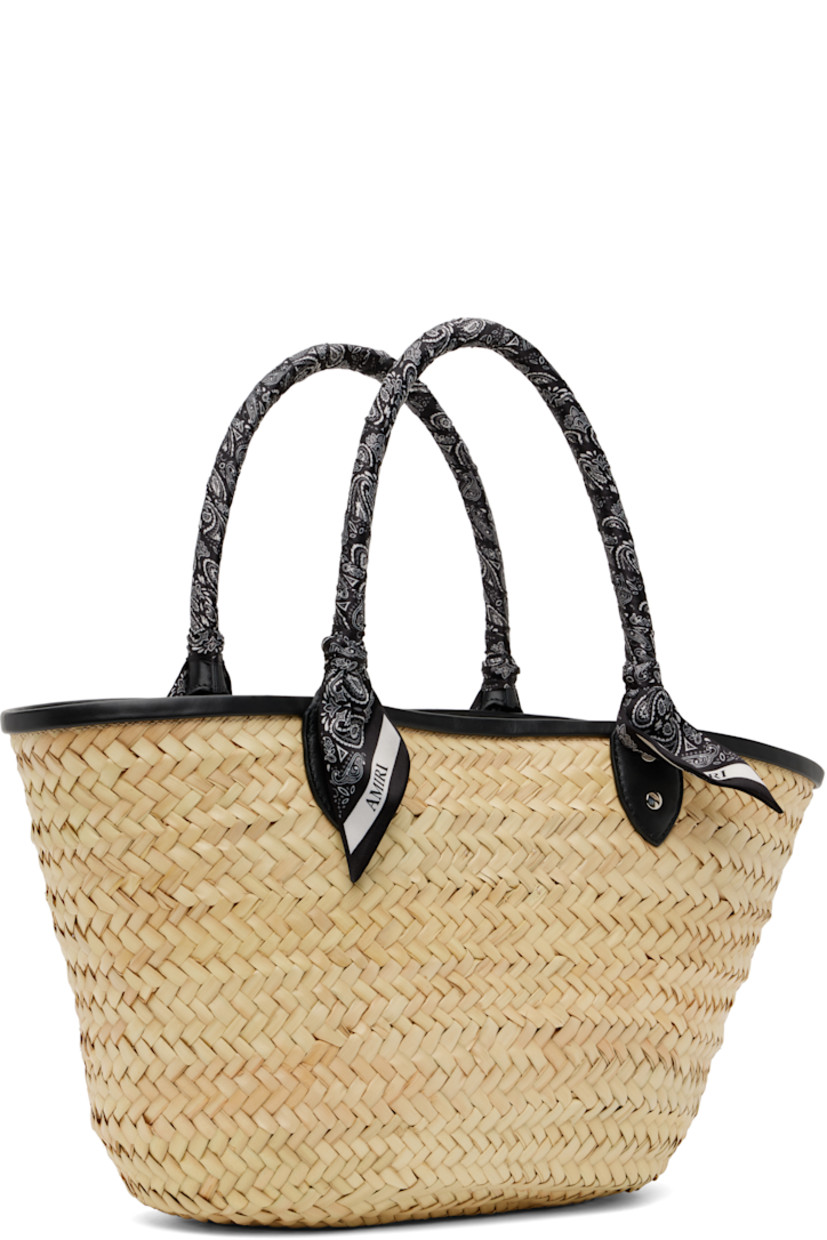 Woven straw tote in beige.

· Buffed leather trim in black throughout
· Bandana-wrapped carry handles
· Logo appliqué at face
· Clasp at throat
· Detachable zip pouch at interior
· H10" x W19" x D5.5"

Supplier color: Black
