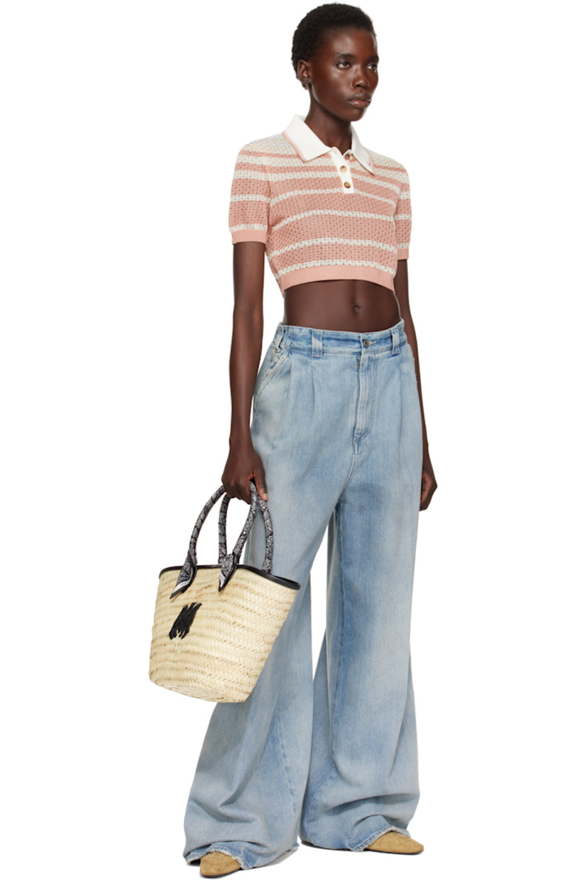 Woven straw tote in beige.

· Buffed leather trim in black throughout
· Bandana-wrapped carry handles
· Logo appliqué at face
· Clasp at throat
· Detachable zip pouch at interior
· H10" x W19" x D5.5"

Supplier color: Black