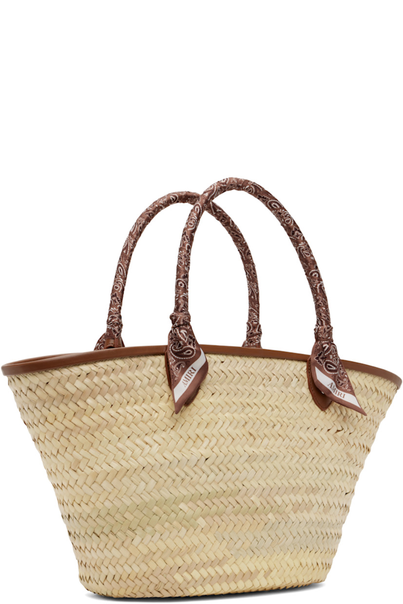 Woven straw tote in beige.

· Buffed leather trim in brown throughout
· Bandana-wrapped carry handles
· Logo appliqué at face
· Clasp at throat
· Detachable zip pouch at interior
· H10" x W19" x D5.5"

Supplier color: Brown
