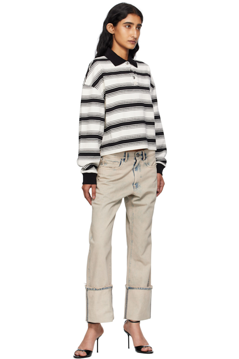 Knit cotton polo.

· Striped pattern throughout
· Rib-knit spread collar and cuffs
· Three-button placket with logo hardware
· Dropped shoulders

Supplier color: Ivory/Black