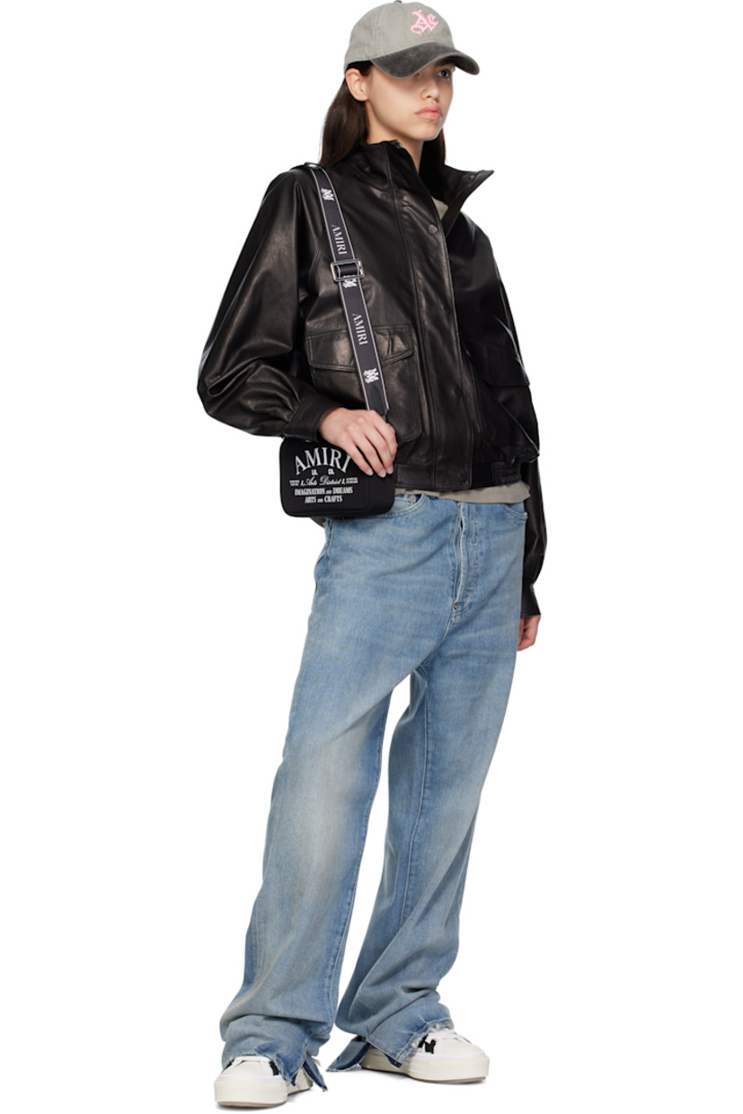Low-top canvas and buffed leather sneakers.

· Rubber cap toe
· Lace-up closure
· Logo embossed at tongue
· Pull-loop at heel collar
· Graphic appliqués at sides
· Buffed leather lining
· Logo embossed at outer midsole
· Treaded rubber sole

Supplier color: Black