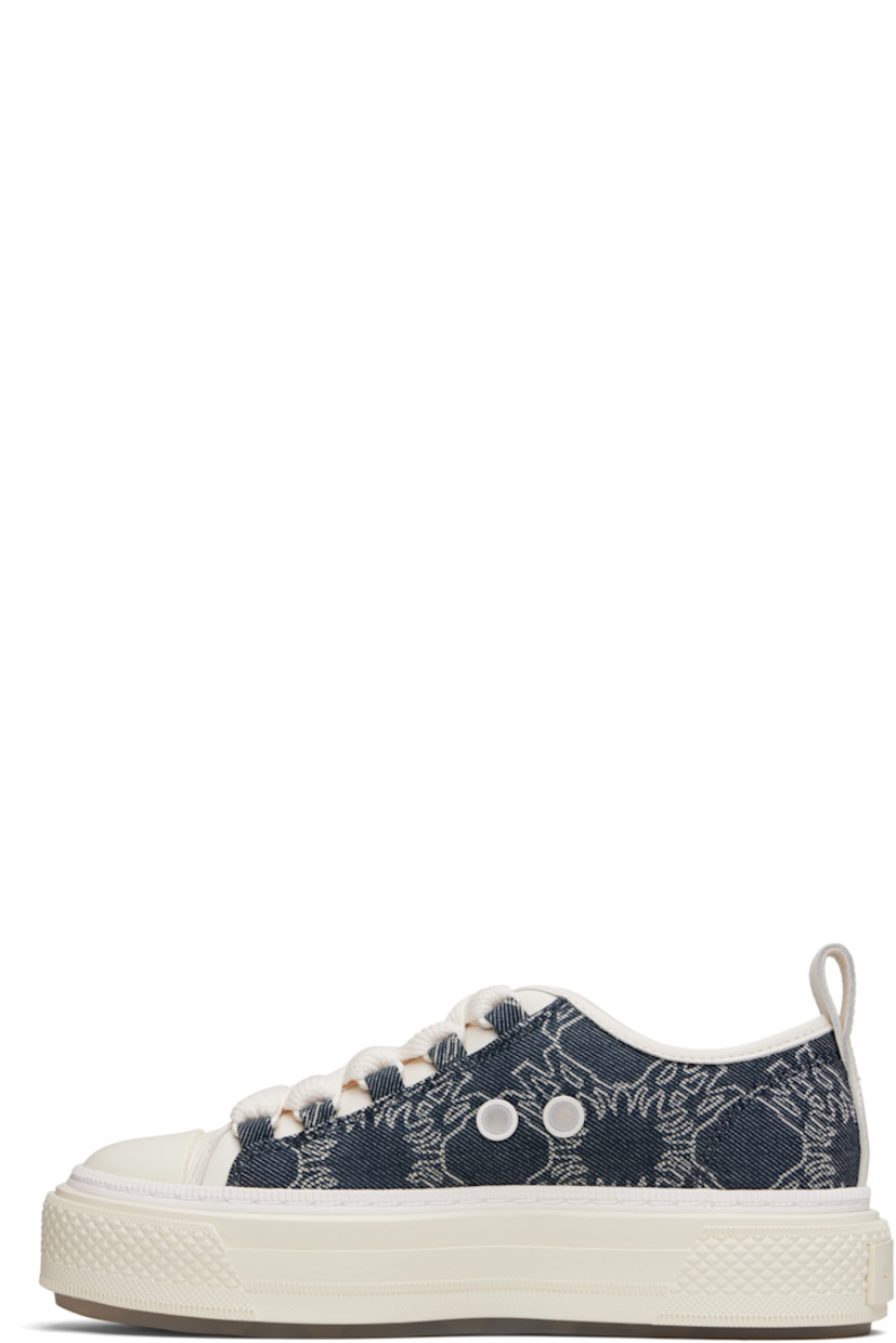 Low-top denim and buffed leather sneakers.

· Jacquard logo pattern throughout
· Rubber cap toe
· Lace-up closure
· Logo embossed at tongue
· Pull-loop at heel collar
· Vents at inner side
· Logo embossed at outer midsole
· Treaded rubber sole

Supplier color: Indigo