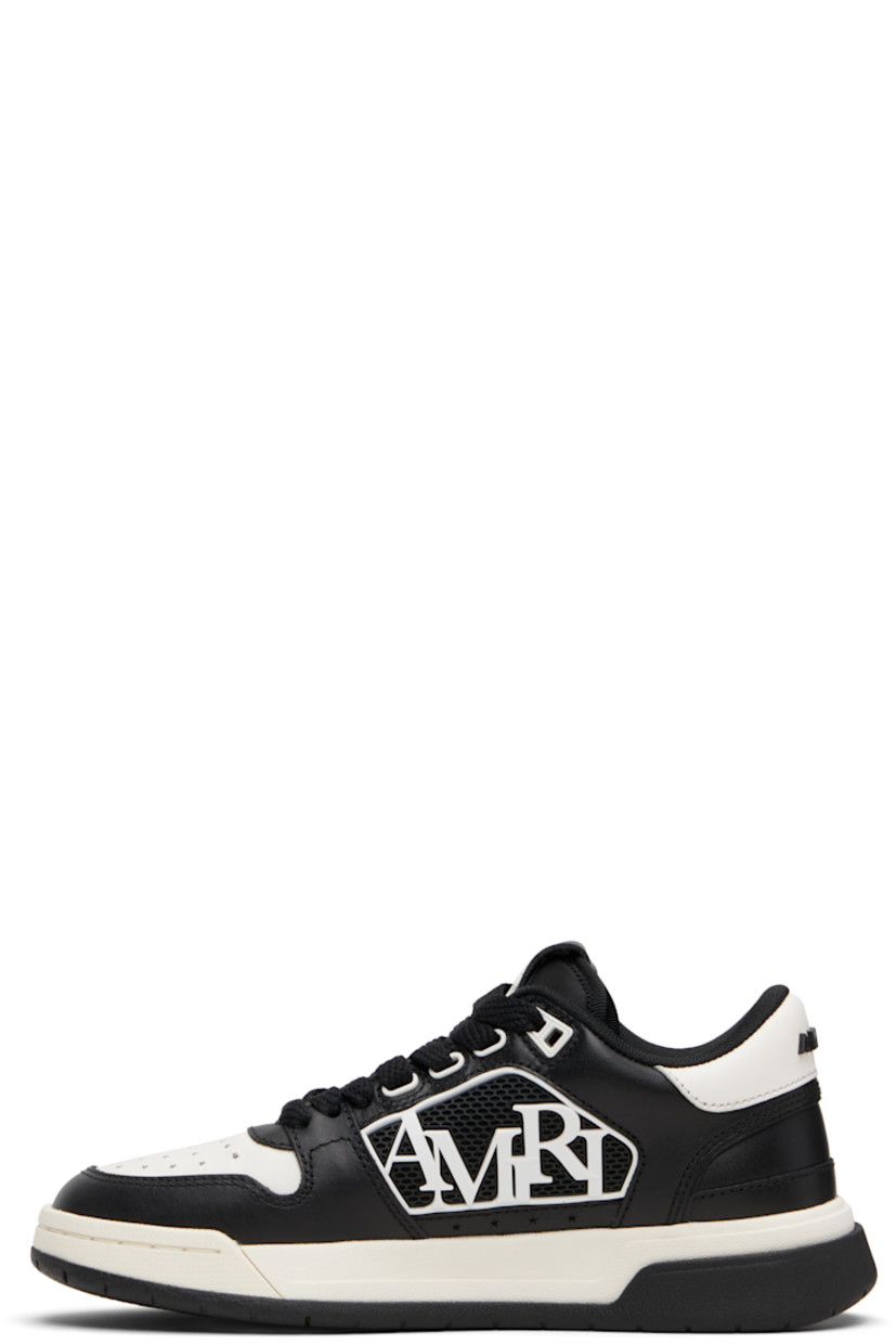 Low-top buffed leather sneakers.

· Graphic perforations at toe
· Lace-up closure
· Logo patch at tongue
· Padded tongue and collar
· Rubberized logo appliqué at sides
· Logo hardware at heel tab
· Mesh lining
· Treaded rubber sole

Supplier color: Black