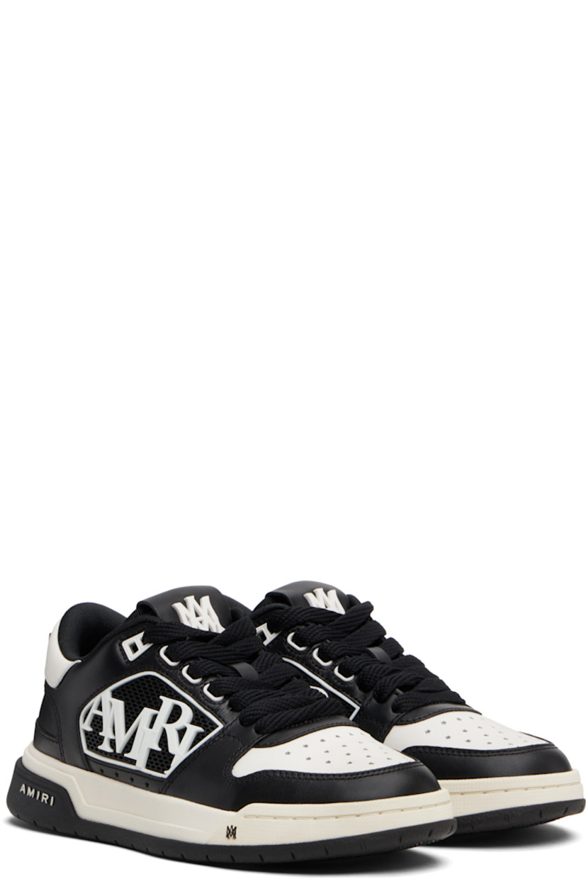 Low-top buffed leather sneakers.

· Graphic perforations at toe
· Lace-up closure
· Logo patch at tongue
· Padded tongue and collar
· Rubberized logo appliqué at sides
· Logo hardware at heel tab
· Mesh lining
· Treaded rubber sole

Supplier color: Black