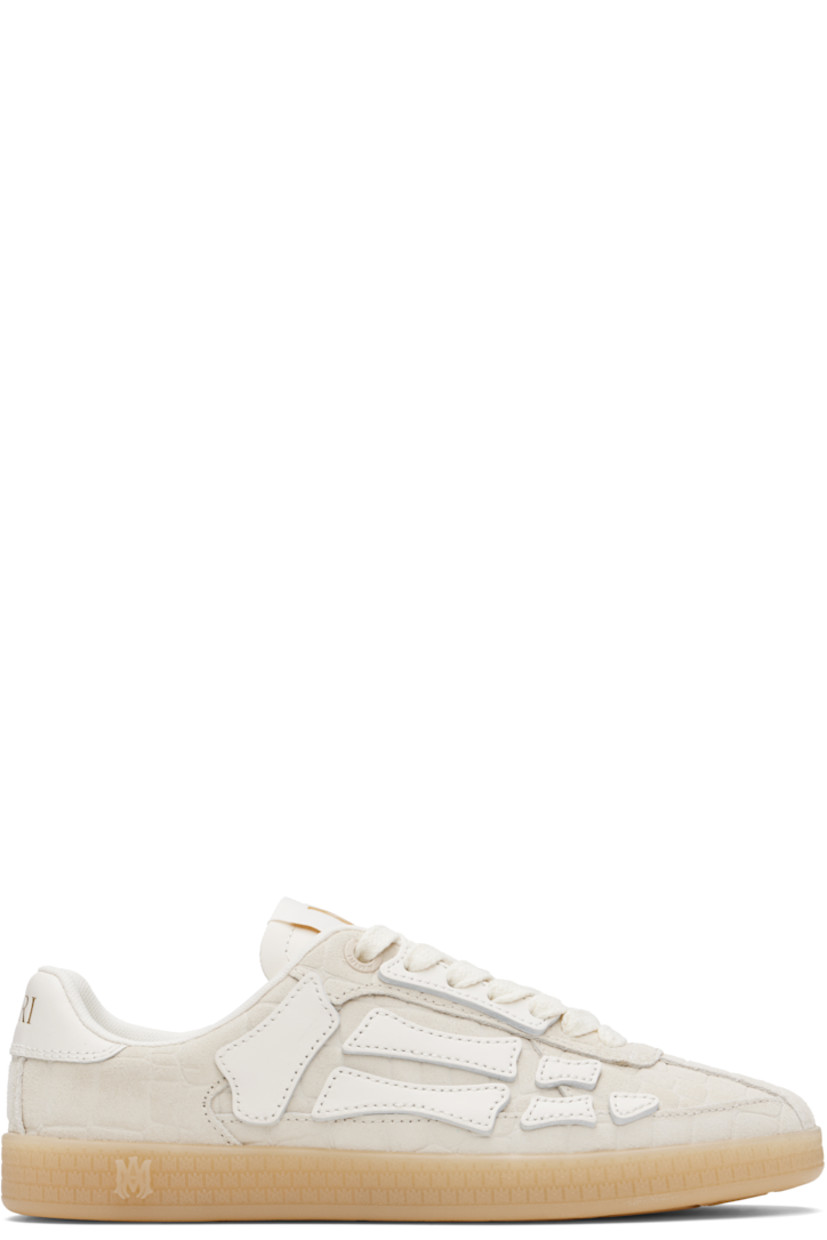 Low-top croc-embossed suede sneakers.

· Lace-up closure
· Logo patch at padded tongue
· Padded collar
· Graphic appliqués at sides
· Logo embossed at heel tab
· Mesh lining
· Logo-embossed textured rubber midsole
· Treaded rubber sole

Supplier color: Alabaster