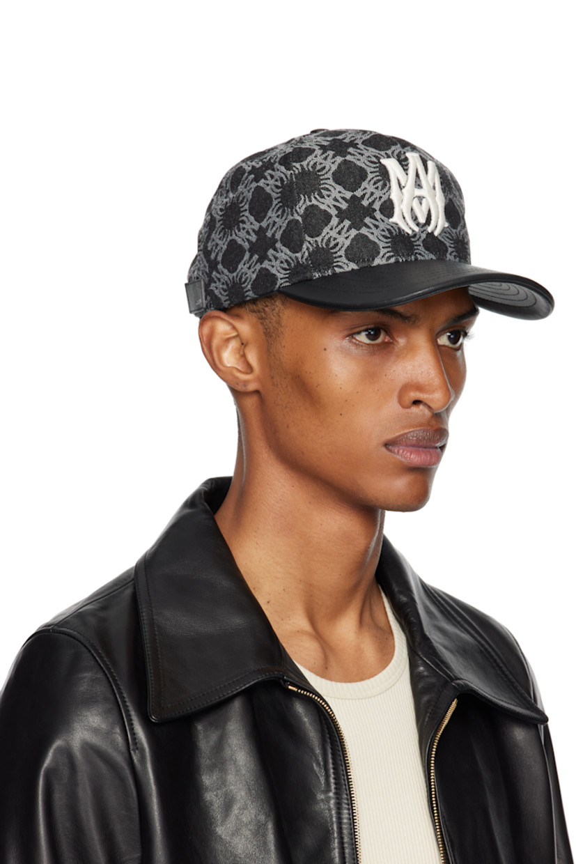Non-stretch denim cap.

· Jacquard logo pattern throughout
· Embroidered eyelets at crown
· Logo embroidered at face and side
· Curved leather brim
· Leather logo patch at back face
· Snapback fastening

Supplier color: Black