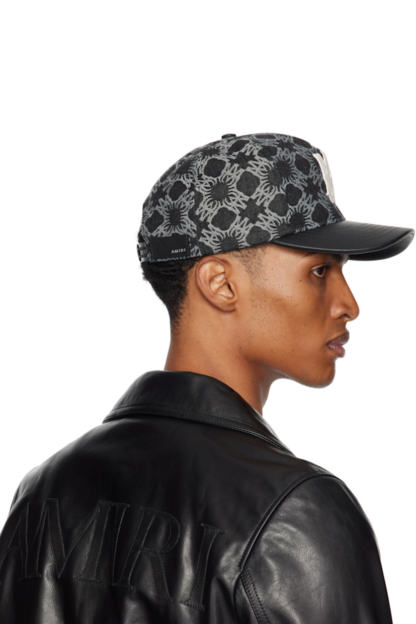 Non-stretch denim cap.

· Jacquard logo pattern throughout
· Embroidered eyelets at crown
· Logo embroidered at face and side
· Curved leather brim
· Leather logo patch at back face
· Snapback fastening

Supplier color: Black