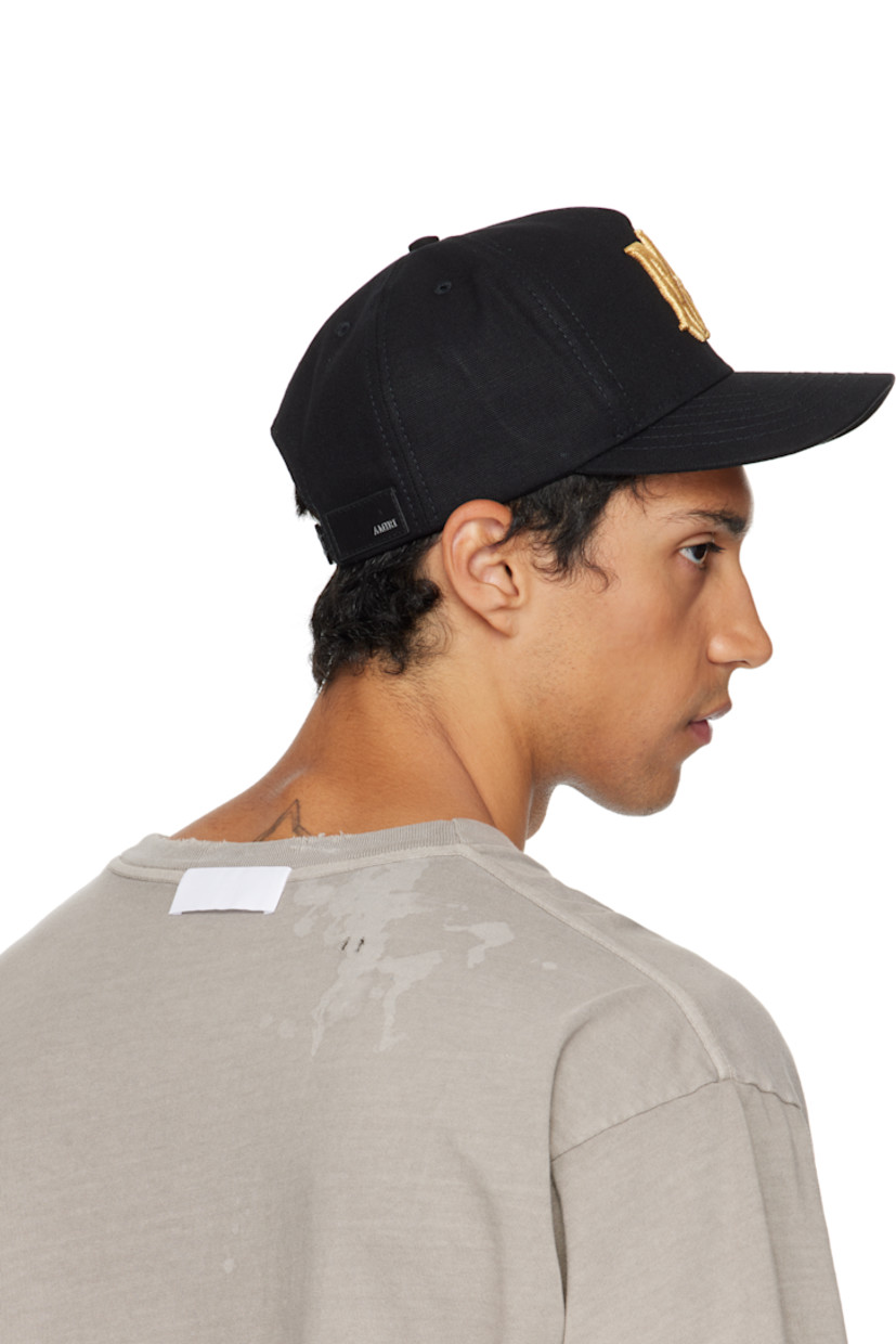 Cotton canvas cap.

· Embroidered eyelets at crown
· Logo embroidered at face
· Curved brim
· Logo patch at back face
· Snapback fastening
· Twill lining

Supplier color: Black