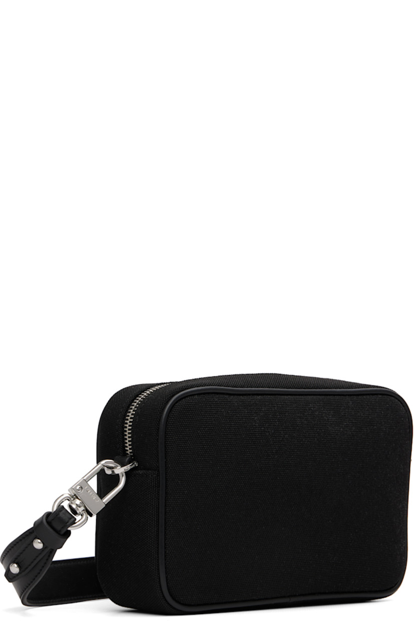 Canvas shoulder bag.

· Adjustable and detachable leather crossbody strap
· Logo embroidered at face
· Zip closure
· Logo-patterned textile lining
· H5" x W8" x D2.5"

Supplier color: Black