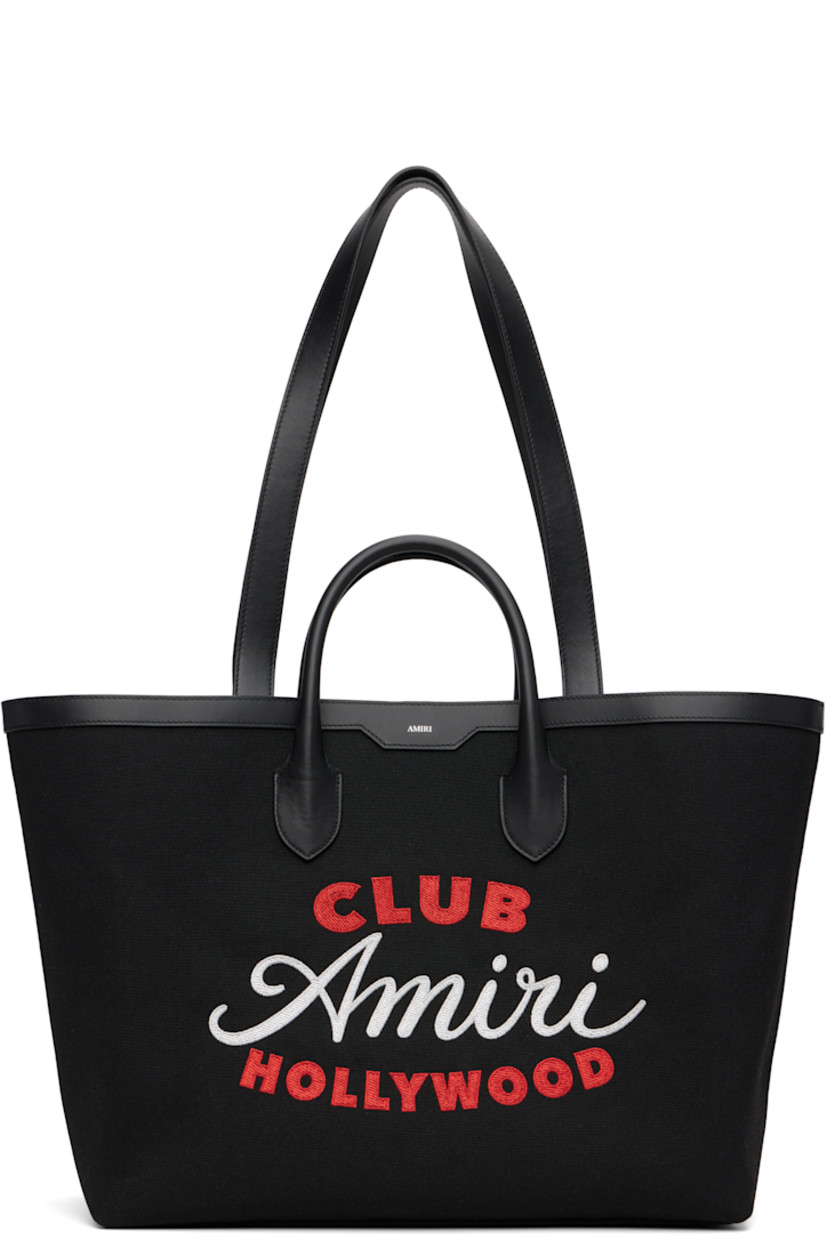 Canvas tote. 

· Buffed leather trim throughout 
· Rolled carry handles
· Fixed shoulder straps 
· Logo stamp at face 
· Embroidered text and logo at face
· Logo-engraved lanyard-clasp closure 
· Zip pocket at interior 
· Full logo-woven satin lining 
· H13" x W21" x D7"

Supplier color: Black