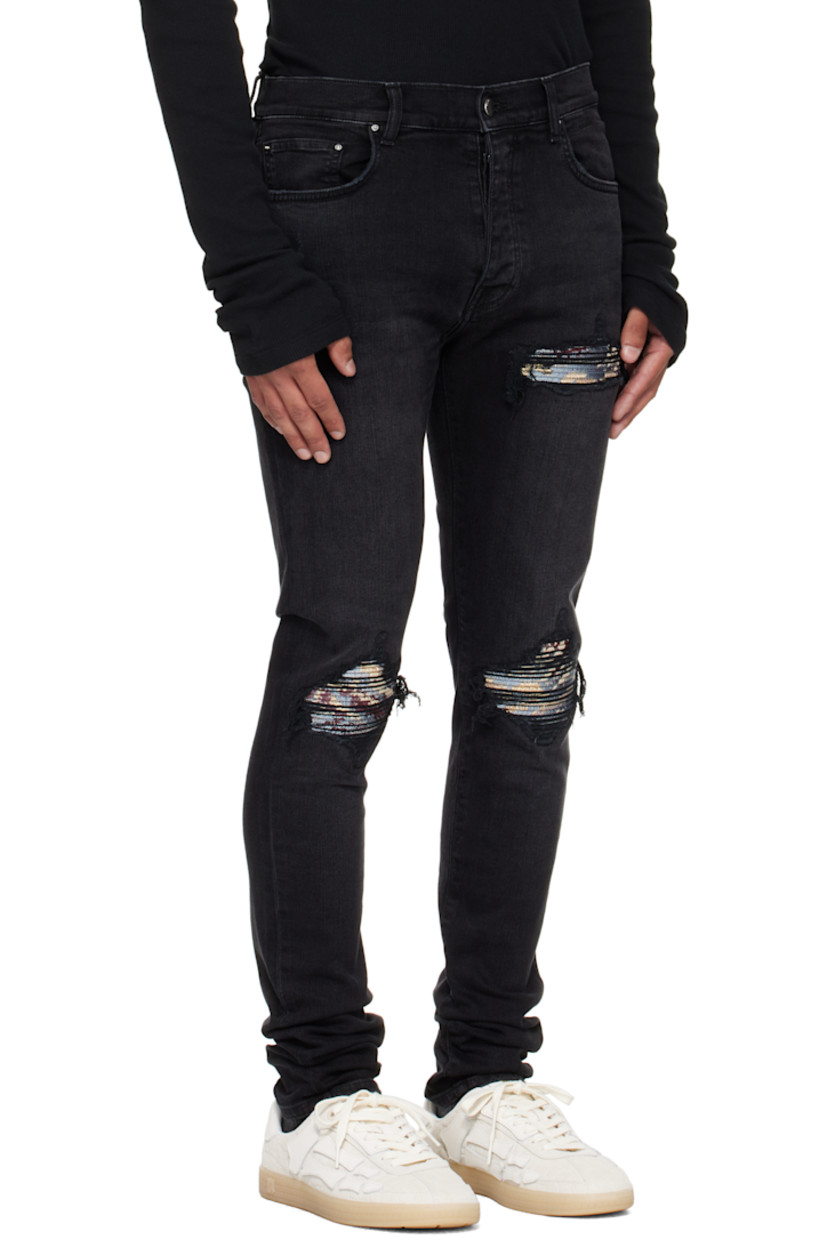 Stretch denim jeans.

· Fading, whiskering, and distressing throughout
· Belt loops
· Five-pocket styling
· Button fly
· Rips with quilted jacquard underlays at front
· Logo patch at back waistband
· Jacquard graphic at back pocket
· Logo plaque at back pocket

Supplier color: Dusk black

Trim: 55% polyester, 27% acetate, 12% cotton, 6% feather.