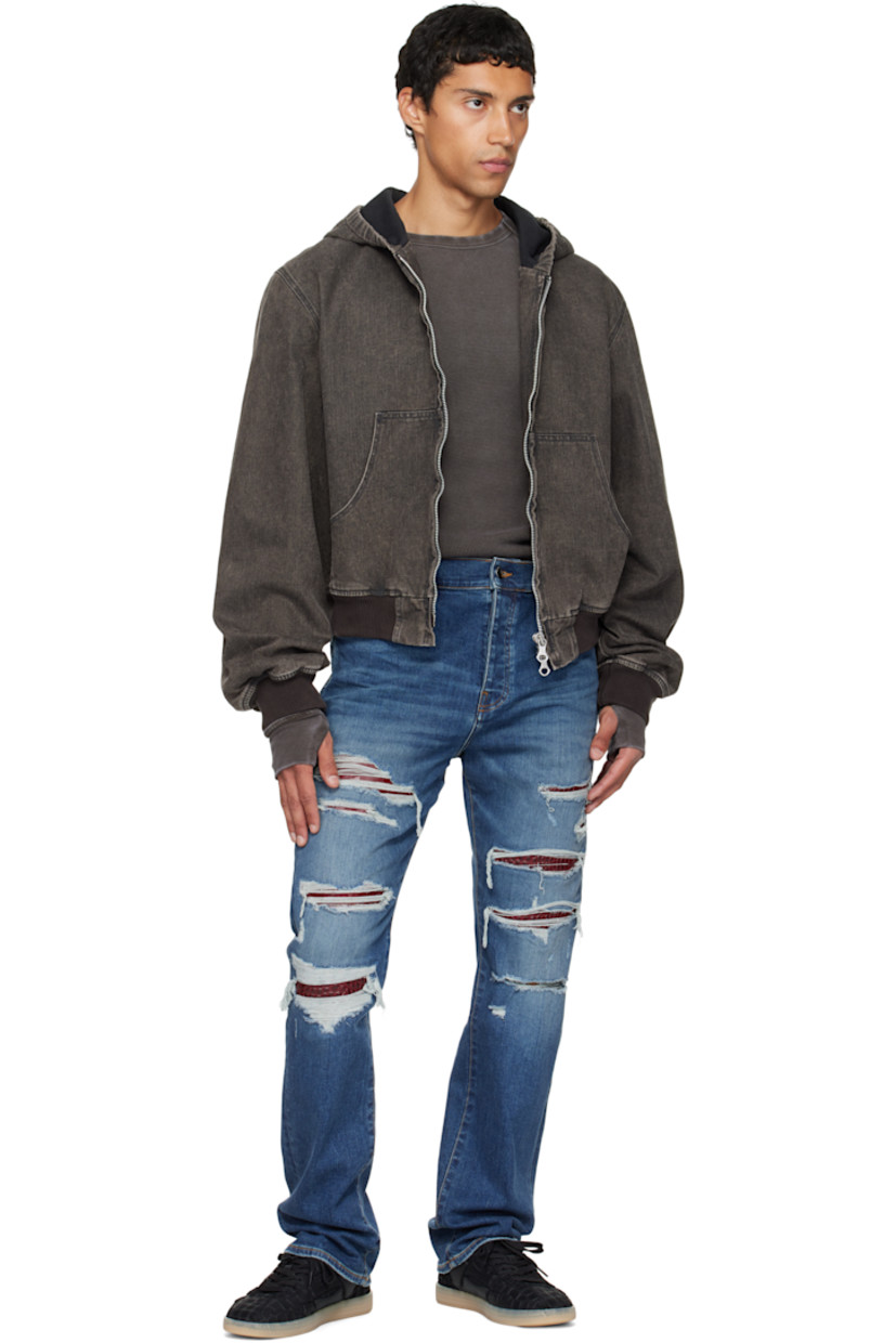 Stretch denim jeans. 

· Fading, distressing, and whiskering throughout 
· Belt loops
· Five-pocket styling
· Button fly 
· Croc-embossed leather panel at legs and back
· Leather logo patch at back waistband
· Logo plaque at back pocket 
· Contrast stitching in tan 

Supplier color: Dark indigo