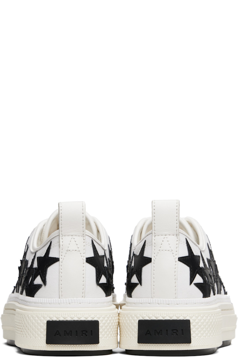 Low-top canvas and buffed leather sneakers.

· Buffed leather trim throughout
· Rubber cap toe
· Lace-up closure
· Logo patch at padded tongue
· Padded collar
· Graphic appliqués at sides
· Logo embossed at outer side
· Pull-loop at heel collar
· Logo embroidered at heel tab
· Buffed leather lining
· Treaded rubber sole

Supplier color: White/Black