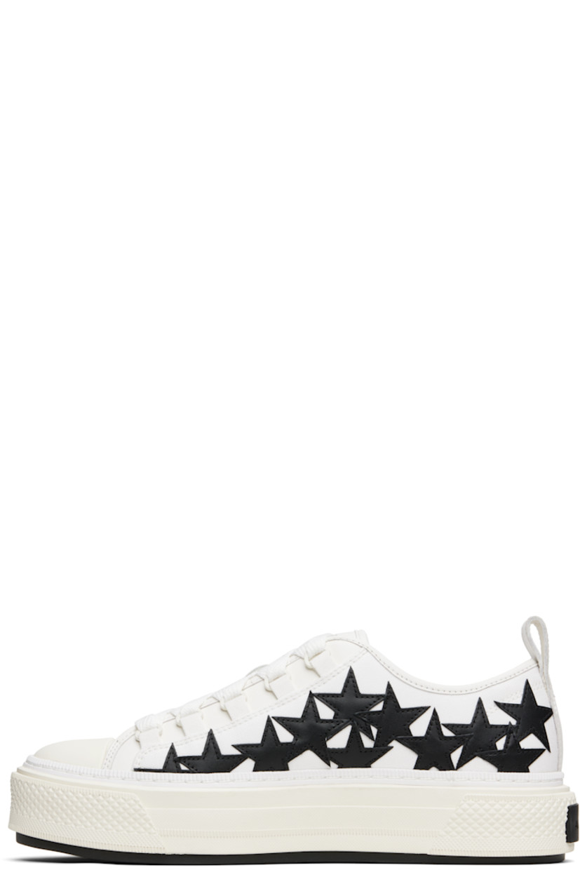 Low-top canvas and buffed leather sneakers.

· Buffed leather trim throughout
· Rubber cap toe
· Lace-up closure
· Logo patch at padded tongue
· Padded collar
· Graphic appliqués at sides
· Logo embossed at outer side
· Pull-loop at heel collar
· Logo embroidered at heel tab
· Buffed leather lining
· Treaded rubber sole

Supplier color: White/Black