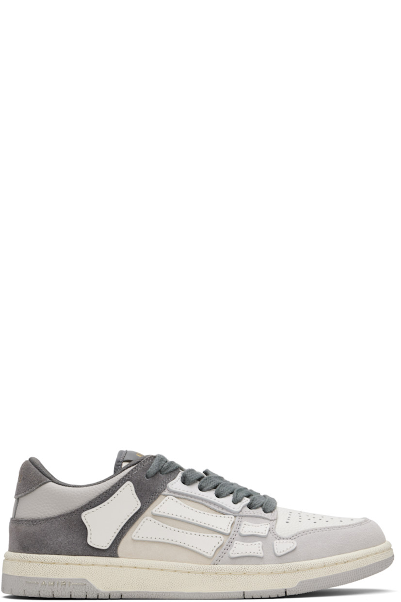 Low-top suede and grained leather sneakers.

· Perforated detailing at toe
· Lace-up closure
· Logo patch at padded tongue
· Padded collar
· Graphic appliqués at sides
· Logo embossed at heel tab
· Mesh lining
· Logo-embossed textured rubber midsole
· Treaded rubber sole

Supplier color: Dark grey