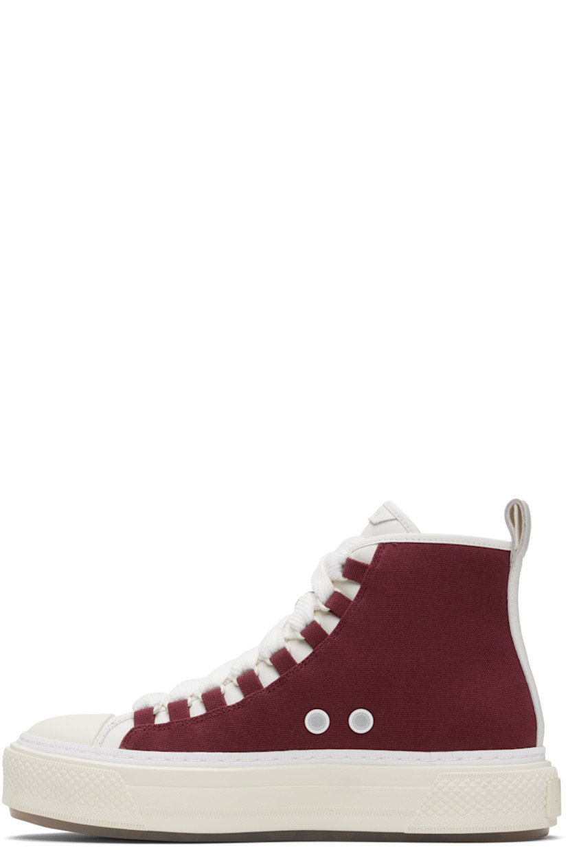 High-top canvas and buffed leather sneakers.

· Rubber cap toe
· Lace-up closure
· Logo patch at padded tongue
· Padded collar
· Logo embroidered and embossed at outer side
· Metal eyelets at inner side
· Pull-loop at heel collar
· Buffed leather lining
· Rubberized logo patch at heel
· Logo embossed at textured rubber midsole
· Treaded rubber sole

Supplier color: Wine